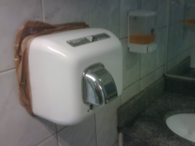 Curiosa manera de sujetar secador de manos en baño de Ripley Valparaiso | Roberto Pinto