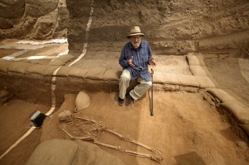 US Archaeologist and professor at Harvard University, Lawrence E. Stager answers AFP journalists quetions next to skeletons at the excavation site of the first Philistine cemetery ever found on June 28, 2016 in the Mediterranean coastal Israeli city of Ashkelon. With an excavation in southern Israel unearthing a Philistine cemetery for the first time, bones of the biblical giant Goliath