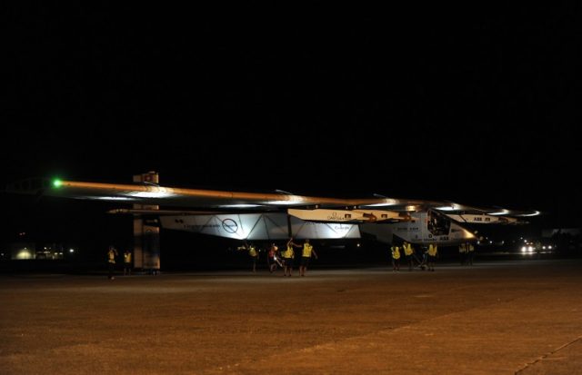 The sun-powered Solar Impulse 2 aircraft is moved onto the tarmac at Sevilla aiport on July 11, 2016, before take off to rally Cairo for the penultimate stage of its world tour. The round-the-world solar flight is estimated to take some 500 flight hours and cover 35,000 km with Swiss founders and pilots, Bertrand Piccard and Andre Borschberg landing every few days to switch between piloting and hosting public events. / AFP PHOTO / CRISTINA QUICLER
