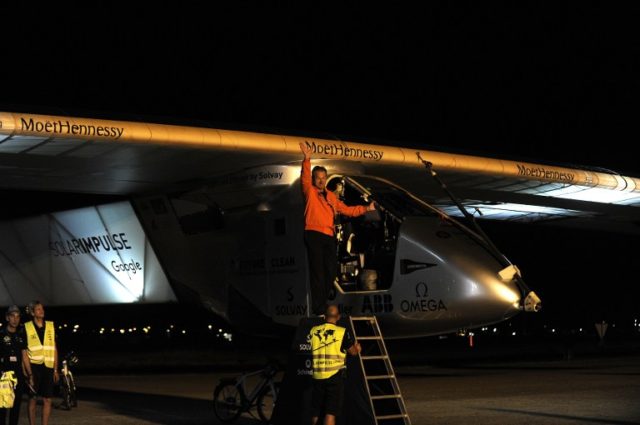 Swiss pilot Andre Borschberg waves before taking off in the sun-powered Solar Impulse 2 aircraft at Sevilla aiport on July 11, 2016, to rally Cairo for the penultimate stage of its world tour. The round-the-world solar flight is estimated to take some 500 flight hours and cover 35,000 km with Swiss founders and pilots, Bertrand Piccard and Andre Borschberg landing every few days to switch between piloting and hosting public events. / AFP PHOTO / CRISTINA QUICLER