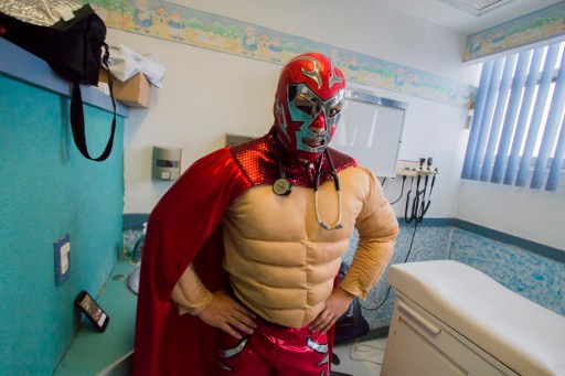Mexican pediatric oncologist Sergio Gallegos, disguised as a traditional Mexican wrestler, poses during an interview with AFP at a hospital in Guadalajara, Mexico on July 12, 2016.  Gallegos believes the mood of his patients is very important for the success of cancer treatment, so he disguises as different characters. / AFP PHOTO / HECTOR GUERRERO