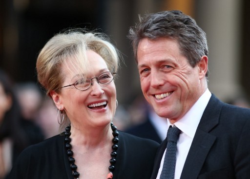 US actress Meryl Streep (L) and British actor Hugh Grant pose on arrival for the premiere of Florence Foster Jenkins in London on April 12, 2016. / AFP PHOTO / JUSTIN TALLIS