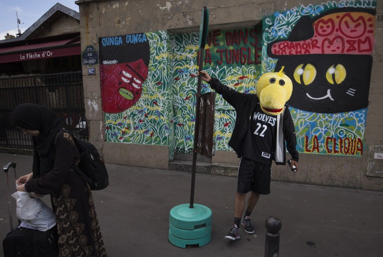 TO GO WITH AFP STORY BY ARIELA NAVARRO (FILES) This file photo taken on August 5, 2016 shows Franco-Colombian street artist Chanoir posing near a painting in Paris. / AFP PHOTO / JOEL SAGET