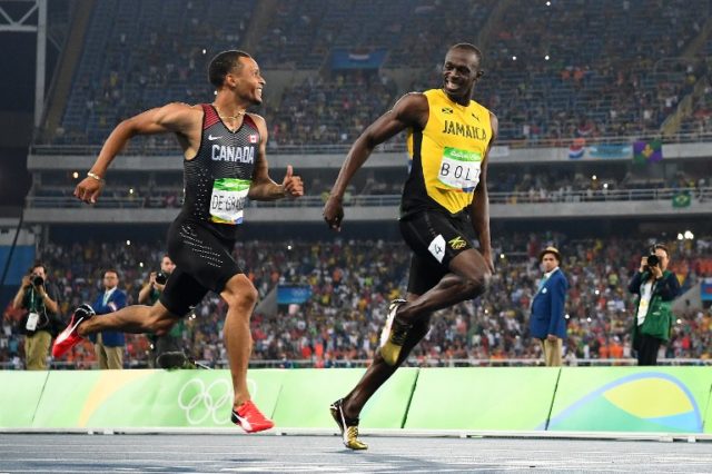 Canada's Andre De Grasse and Jamaica's Usain Bolt compete in the Men's 200m Semifinal during the athletics event at the Rio 2016 Olympic Games at the Olympic Stadium in Rio de Janeiro on August 17, 2016.   / AFP PHOTO / FRANCK FIFE