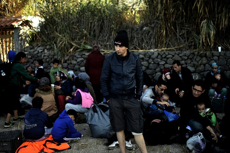 Refugees and migrants rest after arriving at the Greek island of Lesbos after crossing the Aegean sea from Turkey on October 4, 2015. Europe is grappling with its biggest migration challenge since World War II, with the main surge coming from civil war-torn Syria. 