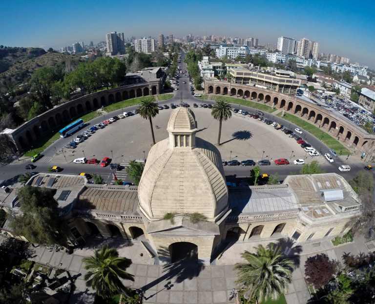 Aerial picture of the General Cemetery of Santiago with the city behind, in Chile, taken on October 13, 2014. Established in 1821, the more than 85-hectare cemetery is now one of the largest in Latin America with an estimated 2 million burials. One of the most visited memorials of the cemetery is that of former President Salvador Allende, who died during the 1973 coup d