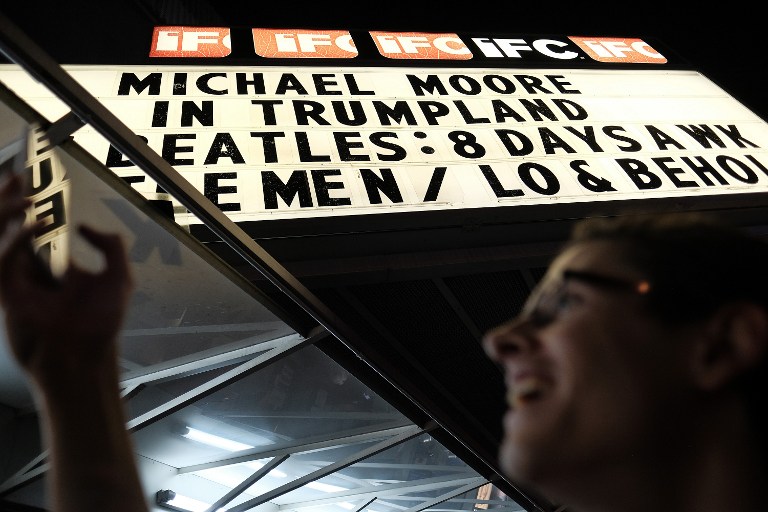 NEW YORK, NY - OCTOBER 18: A moviegoer photographs "Trump Zoltar - The All Seeing Trump" at the premiere of documentary "Michael Moore In TrumpLand" at the IFC Center on October 18, 2016 in New York City. Free tickets to the premiere were distributed at the box office on a first-come-first-serve basis, and then the film was expected to play in Los Angeles and New York City over the weekend and be available via iTunes. 
