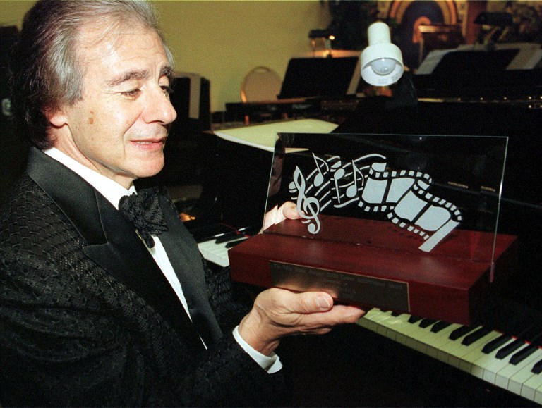 Argentinian-born composer Lalo Schifrin holds the award he recieved for career achievement from the Film Music Society prior to dinner honoring him 06 October 2000 in Hollywood, CA. Schifrin, a multi-Grammy Award winner, is best known for creating the score to the film "Mission Impossible".