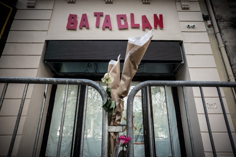 (FILES) This file photo taken on November 01, 2016 shows flowers tied to a fence outside the "Bataclan" concert hall during All Saints