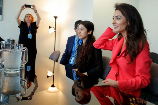 Nadia Murad (2ndR) UNODC goodwill Ambassador and human rights lawyer Amal Clooney (R) attend a meeting with the French Foreign affairs minister Jean-Marc Ayrault at the United Nations Headquarters in New York on September 19, 2016. / AFP PHOTO / POOL / KENA BETANCUR