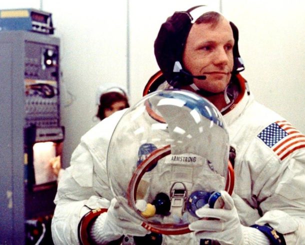 Neil Armstrong, el comandante del Apollo 11, se prepara para ponerse el casco en la sala de preparación de cuarteles en el Edificio de Operaciones  de Naves Espaciales del Centro Espacial de Kennedy.