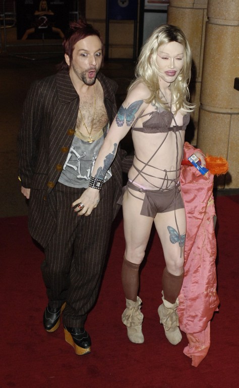 Transvestite Pete Burns, (R), arrives with partner at the Vue cinema in Leicester Square to attend the world premiere of Basic Instinct 2 in London 15 March 2006. AFP Photo/ Andrew Stuart /