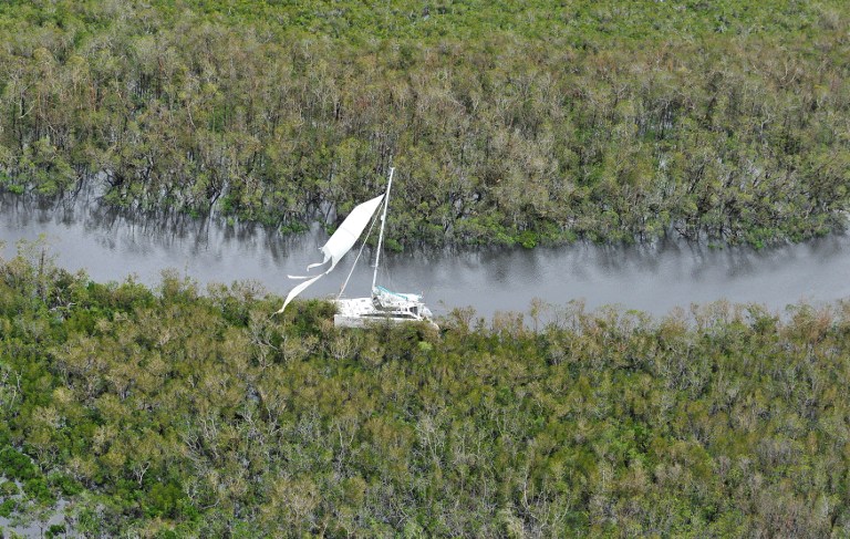 This aerial view shows a catamaran boat washed up on mangroves near Cairns, after Cyclone Yasi, on February 3, 2011. Australia's biggest cyclone in a century shattered entire towns after striking the coast and churning across the vast country, but officials expressed relief that no one was killed. Terrified residents emerged to check the damage after Severe Tropical Cyclone Yasi hit land at around midnight, packing winds of up to 290 kilometres (180 miles) per hour, in a region still reeling from record floods. AFP PHOTO / Paul CROCK / AFP PHOTO / PAUL CROCK