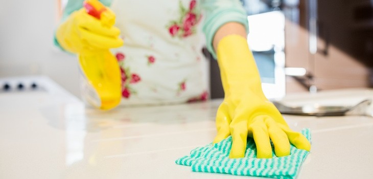 Close-up of woman cleaning kitchen worktop at home