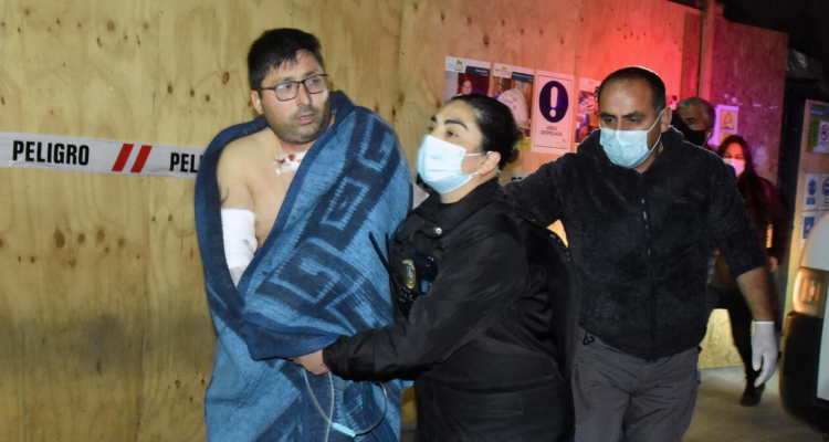 Hombre herido siendo escoltado