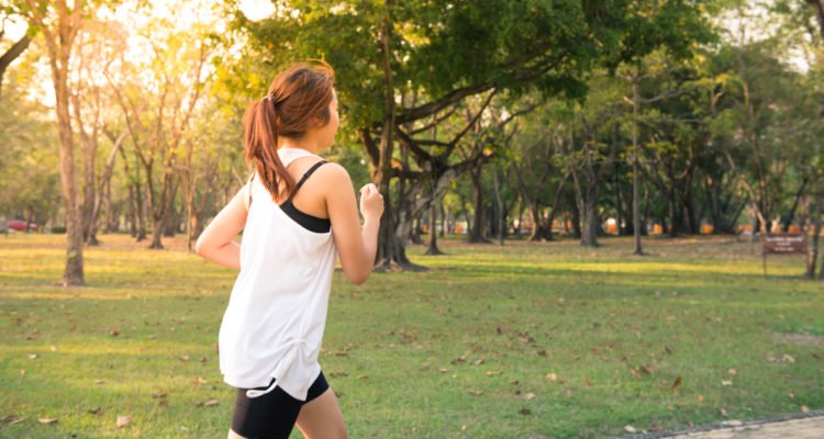 Una mujer corriendo en un parque.