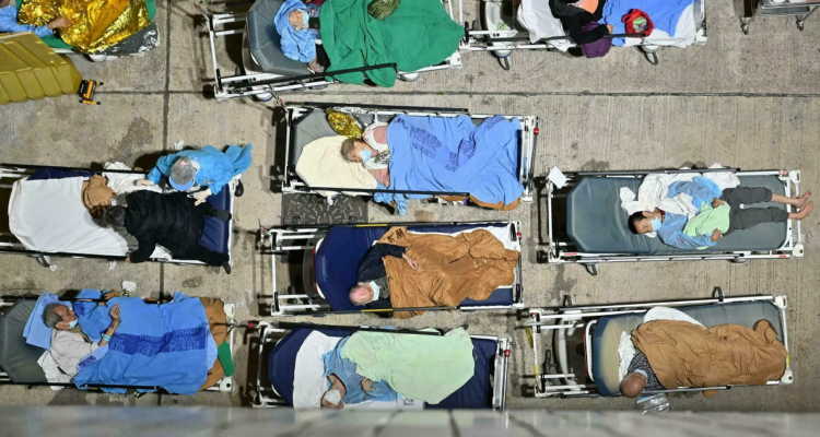 Personas duermen en camas instaladas afuera del hospital Caritas Medical Centre de Hong Kong.