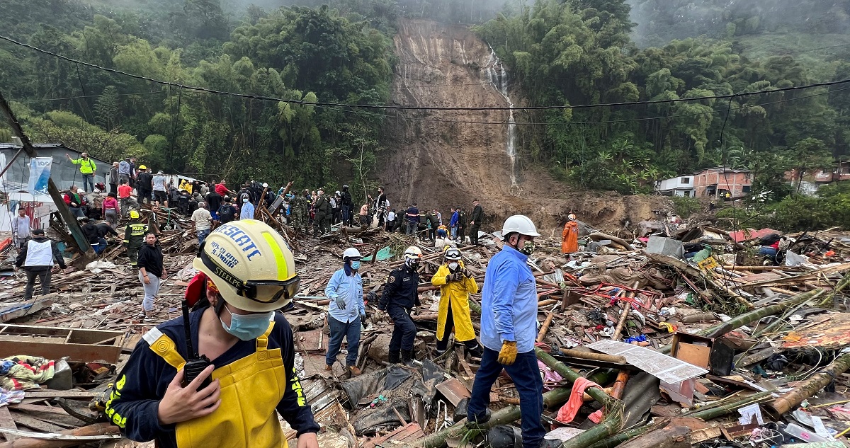 Autoridades y miembros de cuerpos de rescate trabajan en una zona afectada por un deslizamiento de tierra causado por las fuertes lluvias.