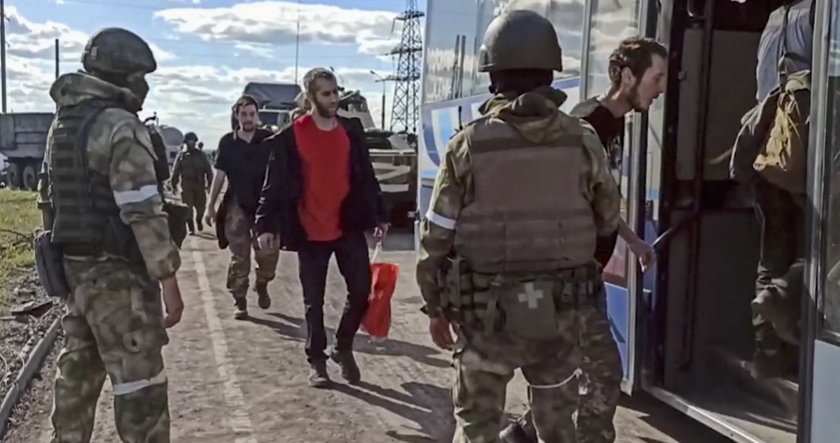 Militares rusos trasladan a combatientes rendidos en la acería de Azovstal.