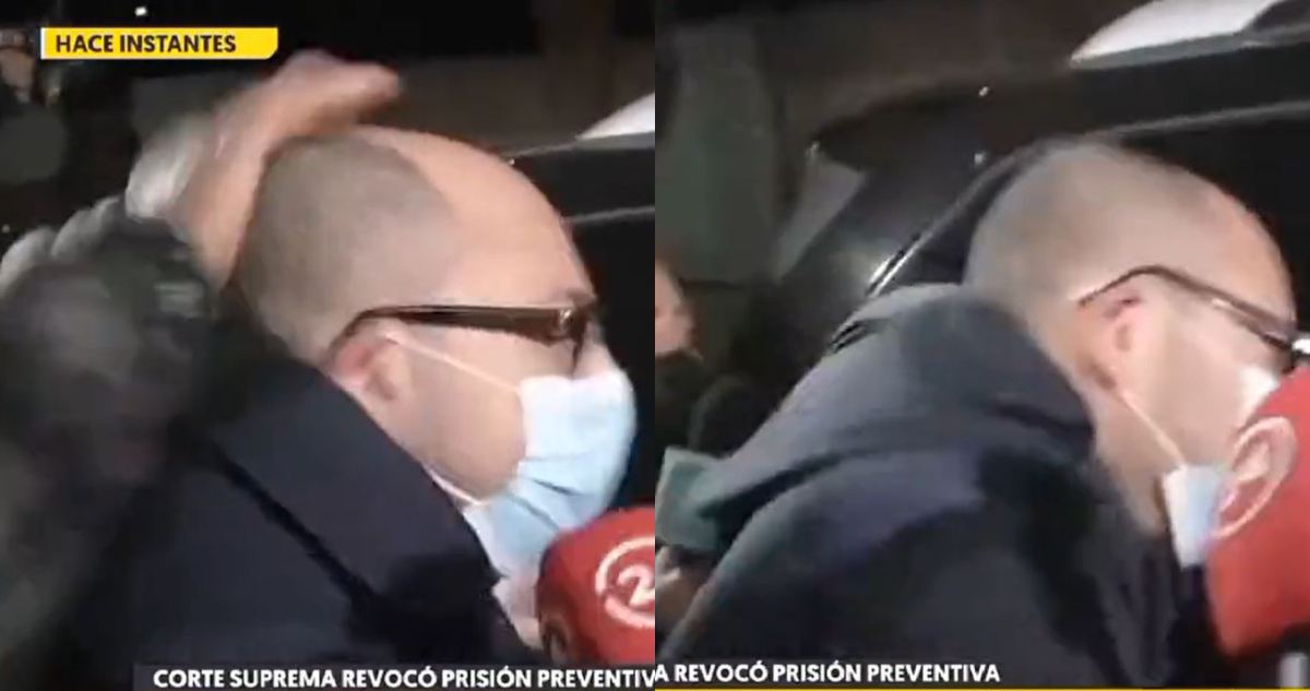 Nicolás López abre la puerta de su auto, momento en el que lo agreden. En las imágenes se ve una mano golpeándo al director y cómo este se hace hacia adelante por el impacto.