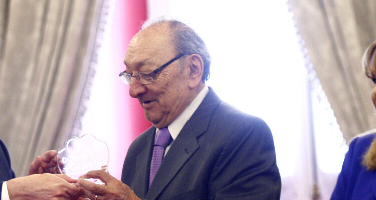 Javier Miranda mira hacia un costado sonriente mientras recibe un premio.