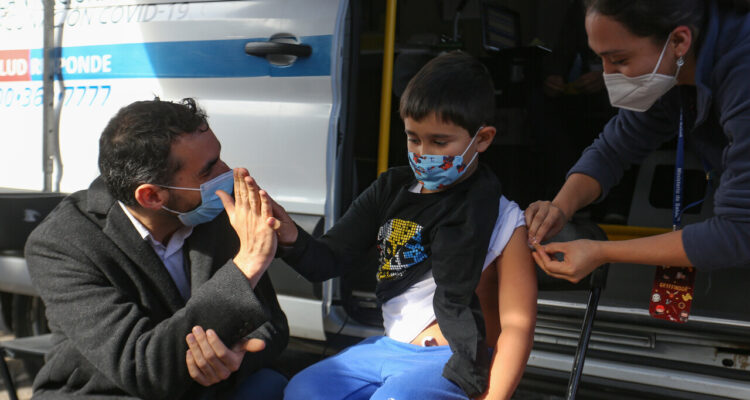 Niño siendo vacunado junto al subsecretario de Salud Pública, Cristóbal Cuadrado.