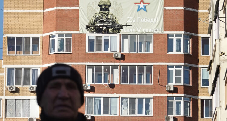 A man walks next to a poster reading ‘For Victory’ and ‘Power in Truth’ in support of the Special military operation in Ukraine, Moscow, Russia, 12 October 2022. The letters Z, V and O, painted on Russian military vehicles in Ukraine, have quickly become a symbol of support of the Russian army