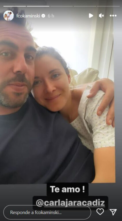 El animador Francisco Kaminski abraza a su esposa con una leve sonrisa desde el interior de la clínica.