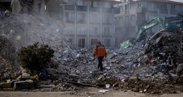 Un rescatista camina entre los escombros dejados por los sismos en Turquía.