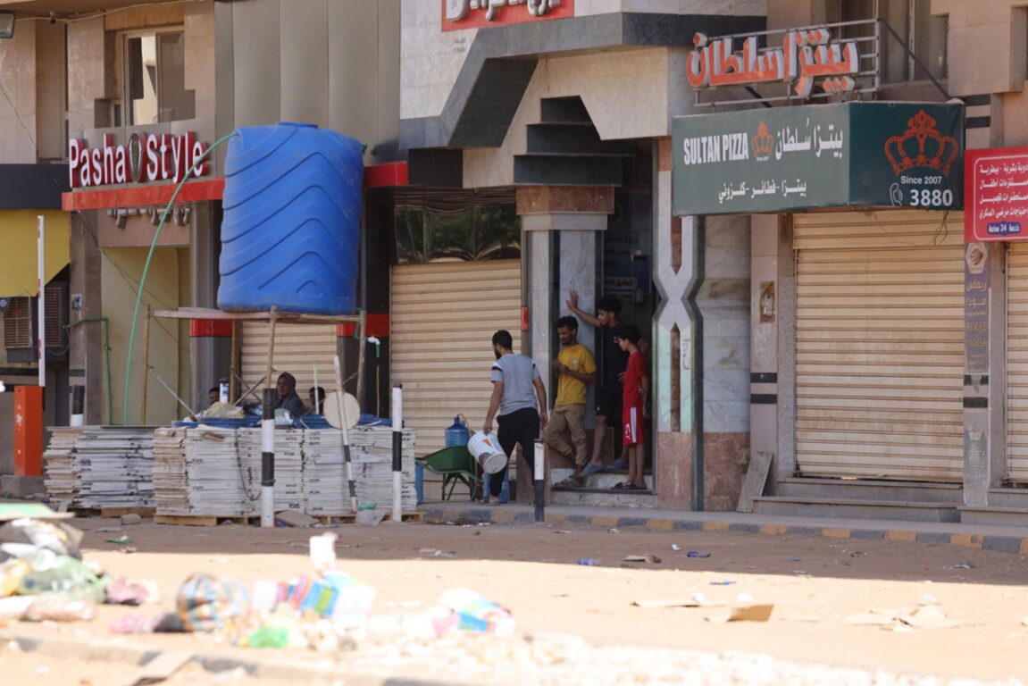 Sudaneses frente a una tienda en Jartum 