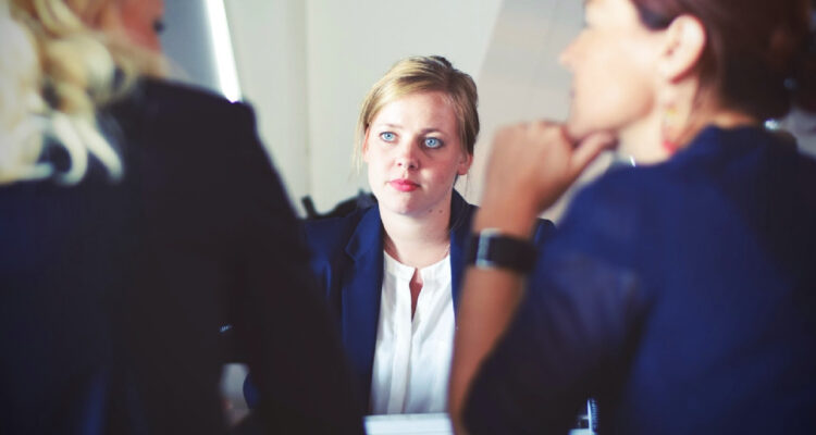 Una jóven frente a dos mujeres en una entrevista de trabajo
