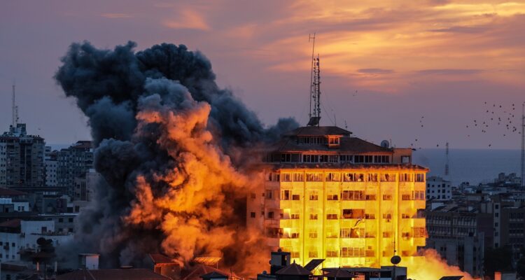 Smoke rises after Israeli warplanes targeted the Palestine tower in Gaza City, 07 October 2023.. Rocket barrages were launched from the Gaza Strip early 07 October in a surprise attack claimed by the Islamist movement Hamas. In a televised statement, the Israeli prime minister said the country is at war.