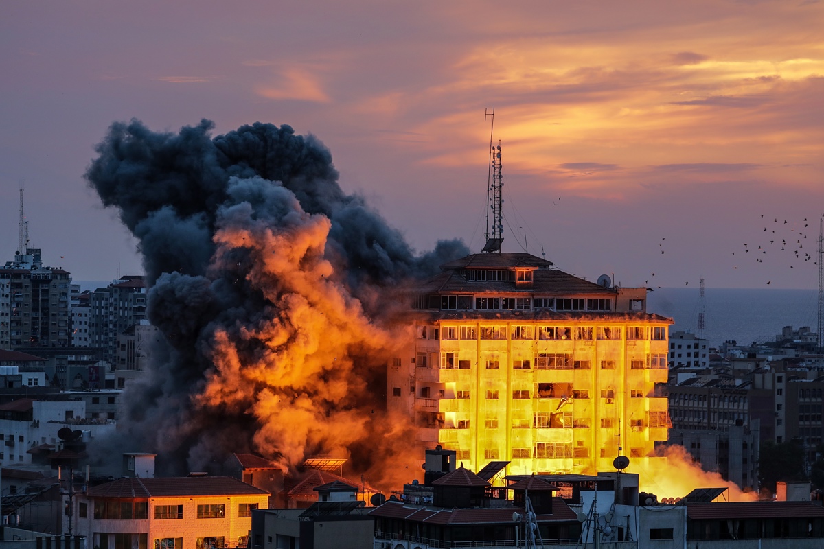 Smoke rises after Israeli warplanes targeted the Palestine tower in Gaza City, 07 October 2023.. Rocket barrages were launched from the Gaza Strip early 07 October in a surprise attack claimed by the Islamist movement Hamas. In a televised statement, the Israeli prime minister said the country is at war.