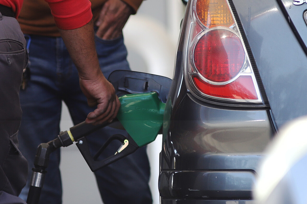 Hombre echando gasolina en un vehículo: detalle del surtidor