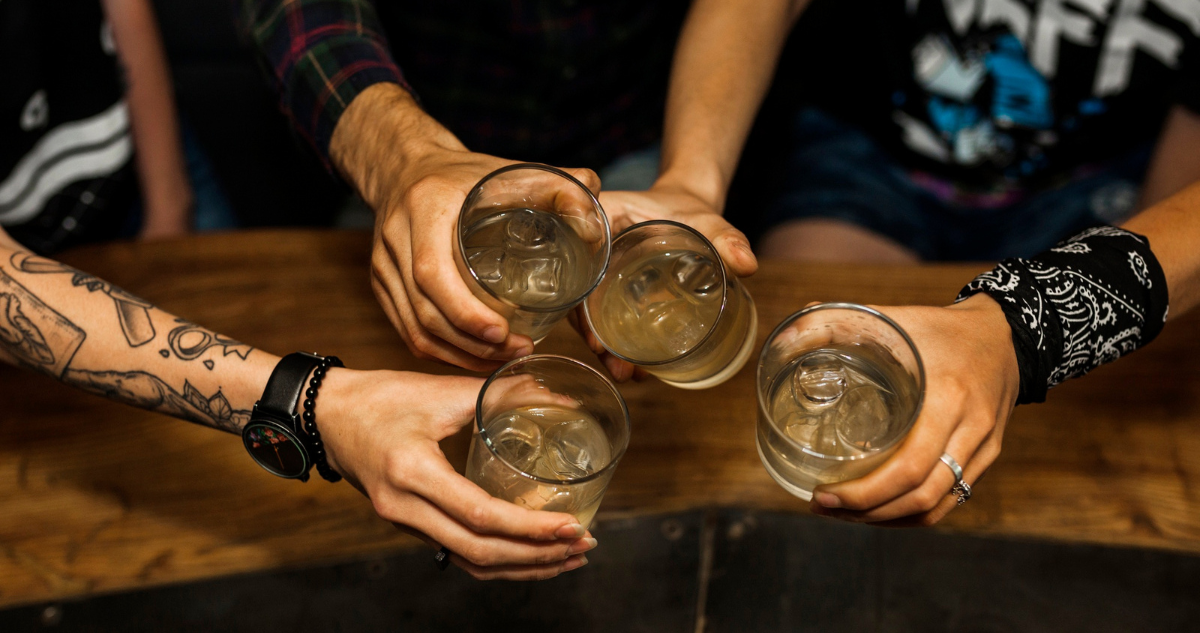 Grupo de amigos compartiendo cócteles alcohólicos