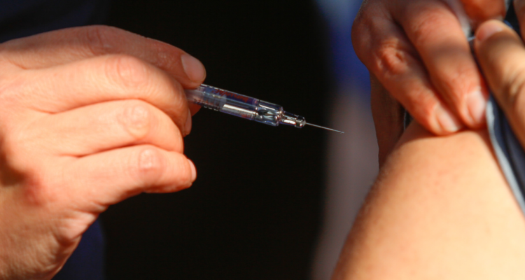 Persona siendo inoculada por tasa de vacunación de influenza en Temuco y Lonquimay