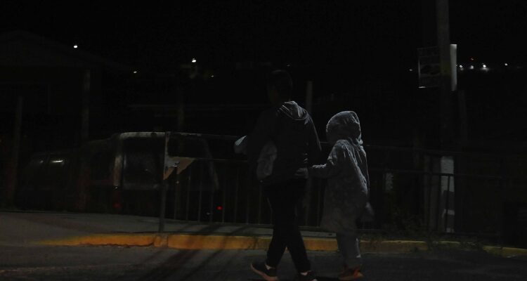 Personas paseando en la calle sin luz