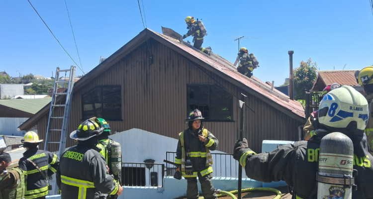 Bomberos trabajando en el control de incendio de casa en Concepción