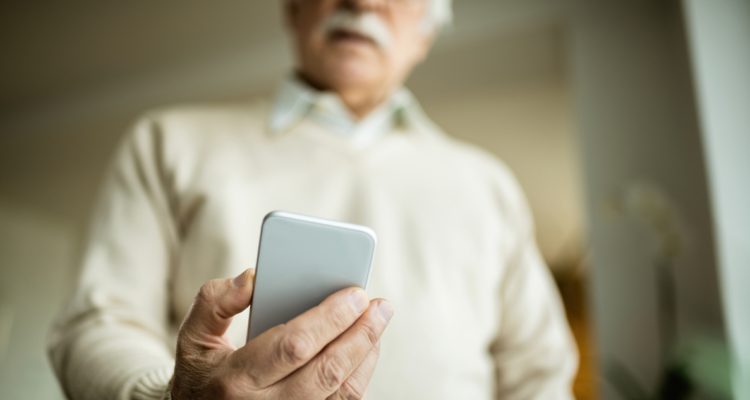 Adulto mayor usando el celular