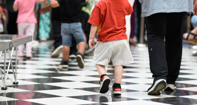 Foto de contexto de niño caminando junto a un adulto